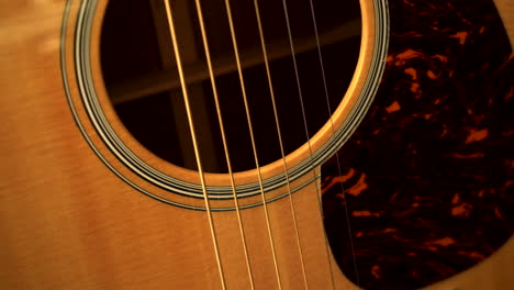 passing over an acoustic guitar