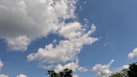 time lapse of the movement of white clouds in a blue sky, weather changing from sunny to slightly cloudy