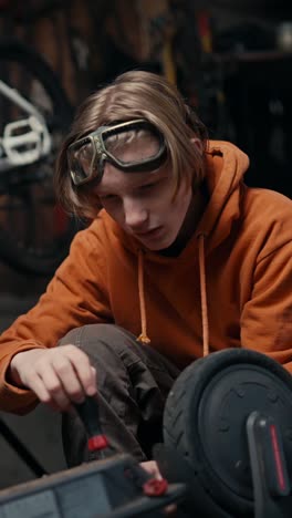 teenager repairing an electric scooter
