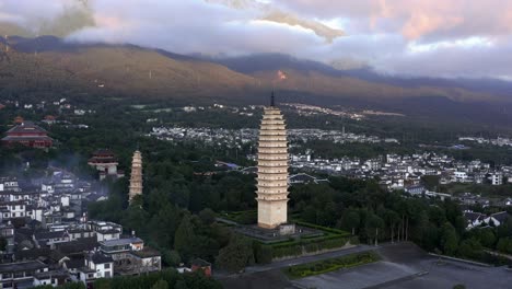 beautiful chinese buddhist temple, pagoda towers at sunset in dali, aerial