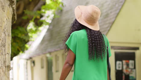 rear view of female tourist on vacation in oxford uk exploring city street walking along lamb and flag passage 2