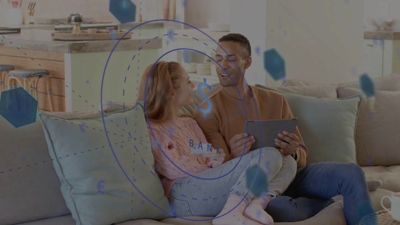 Man tapping tablet and woman leaning on sofa, activating overlay with dollar sign for banking