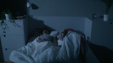 couple sleeping in bed at night