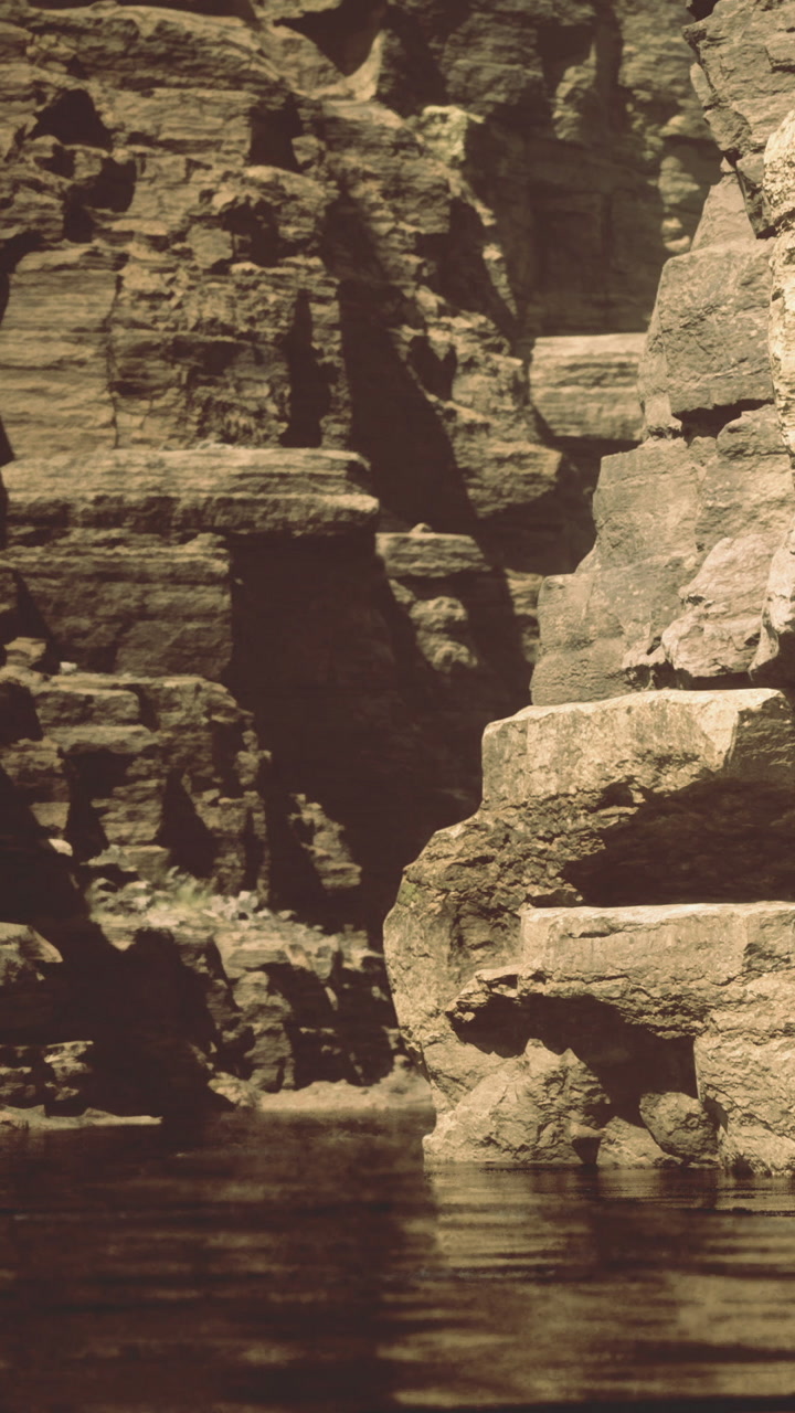 Gentle waters reflect ancient rocks in a serene natural landscape