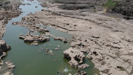 Aerial-drone-footage-of-a-river-with-potholes---At-Nighoj-near-Pune-and-is-famous-for-the-naturally-created-potholes-on-the-riverbed-of-the-Kukadi-River