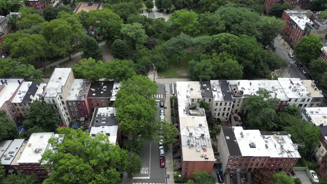 Reverse drone shot revealing Jersey City park expanding into skyline views, blending green space and urban architecture. Ideal for real estate, travel, or cinematic stock footage
