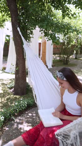 woman reading in a hammock