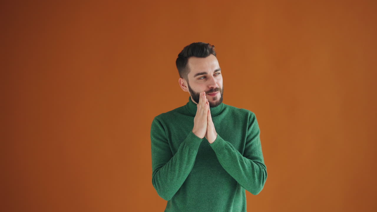 Man in Green Sweater Praying