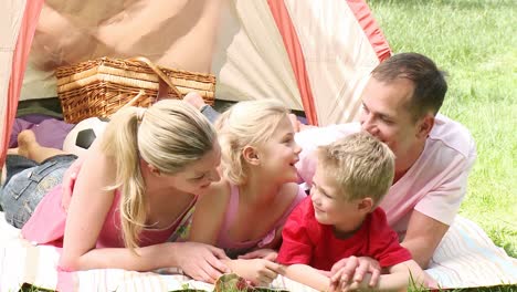 family camping relaxing on the grass