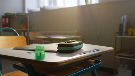 supplies on table in auditorium at campus. classroom with desks and chairs