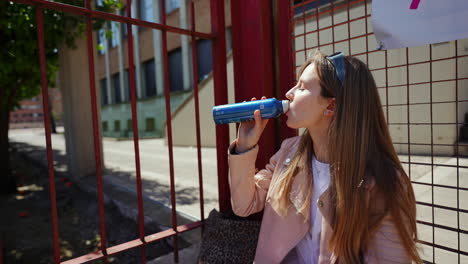 Young Woman Drinking Outside