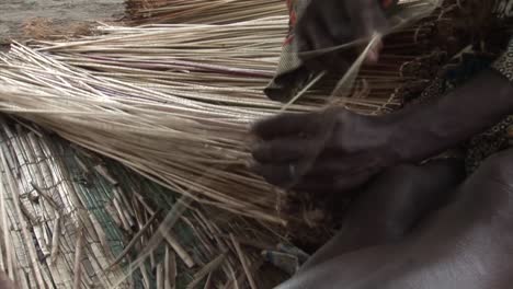 a nigerian woman crafting a mat