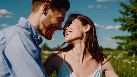 happy couple embracing in a sunny field
