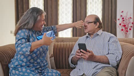 Old-Indian-woman-surprising-her-husband-with-a-gift