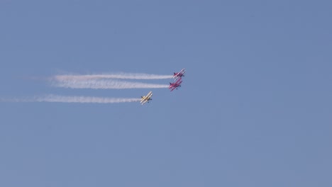 precision flying with colorful smoke trails