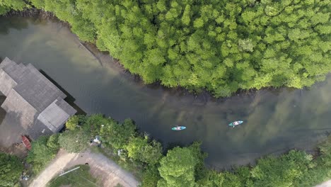 crossing river with 2 kayaks