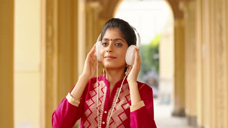 pretty indian woman listening to music