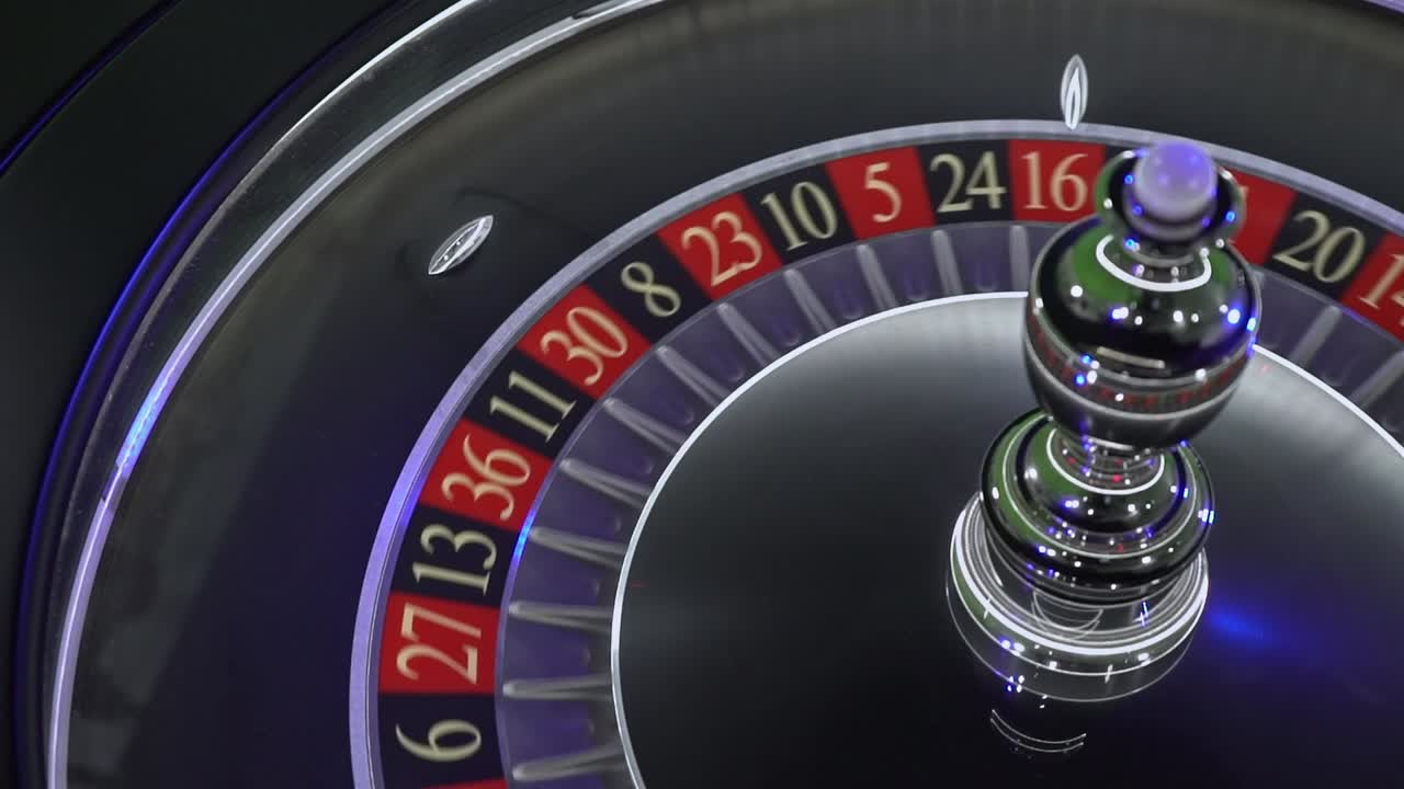 Precise roulette wheel rotation capturing spinning ball trajectory landing randomly on numbered slot during high-stakes gambling moment