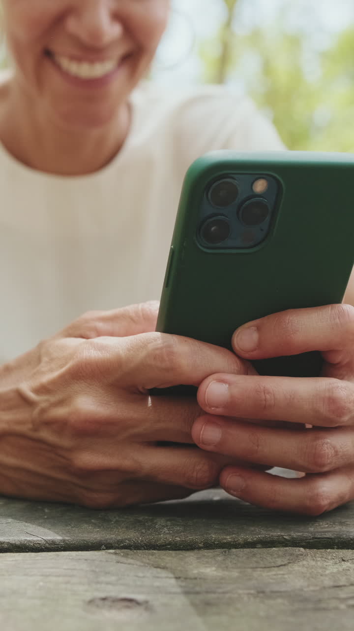 Close-up of Person's Hands Using Smartphone Outdoors