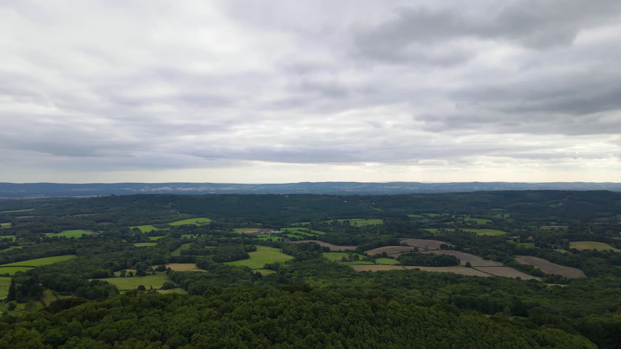 Hazlemere countryside on cloudy day, England. Aerial forward