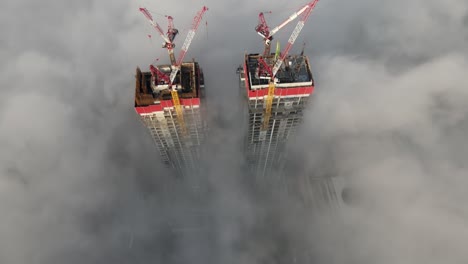 foggy construction of twin skyscrapers