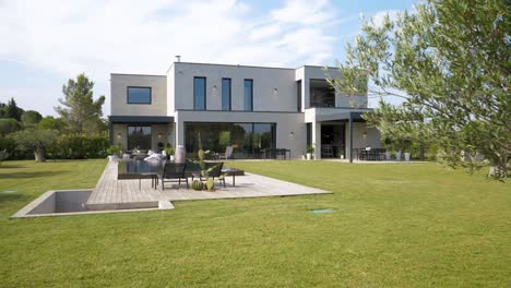 revealing shot of a modern villa in the uzes countryside with a reflection pool