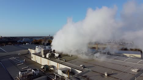 Pan-shot-of-industrial-chimney-smoke-in-Manchester