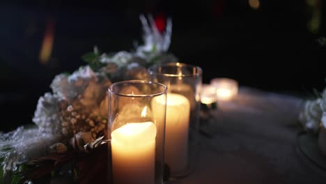 warm candlelight illuminates soft floral decor, creating a serene, intimate ambiance