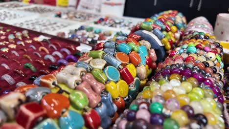 colorful handmade bracelets and beads at a market stall