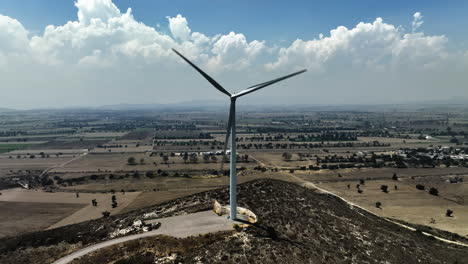 aerial view in front of a large wind turbine in puebla, mexico - ascending, tilt, drone shot