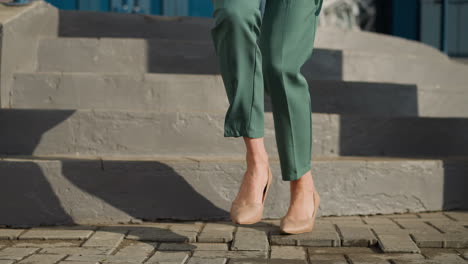female legs in classic business outfit move on street