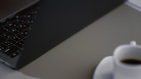 African-american-woman-using-touchpad-laptop.-Hands-browsing-computer-in-cafe.