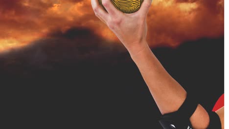 Animation-of-hand-of-caucasian-female-handball-player-holding-ball-over-clouds