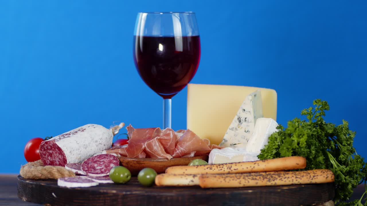 Antipasto with a glass of wine slowly rotates.