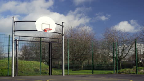 Basketball-hoop-beside-cars-on-freeway-passing