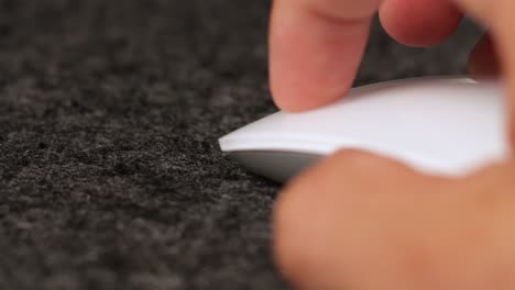 close up of male latino hand using a white wireless mouse