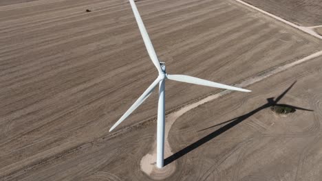 aerial drone shot of wind turbines spinning