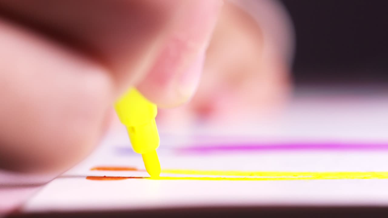 Child coloring with yellow marker