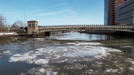 rising drone shot ice down river winter floating ascending slow long shot wilmington delaware