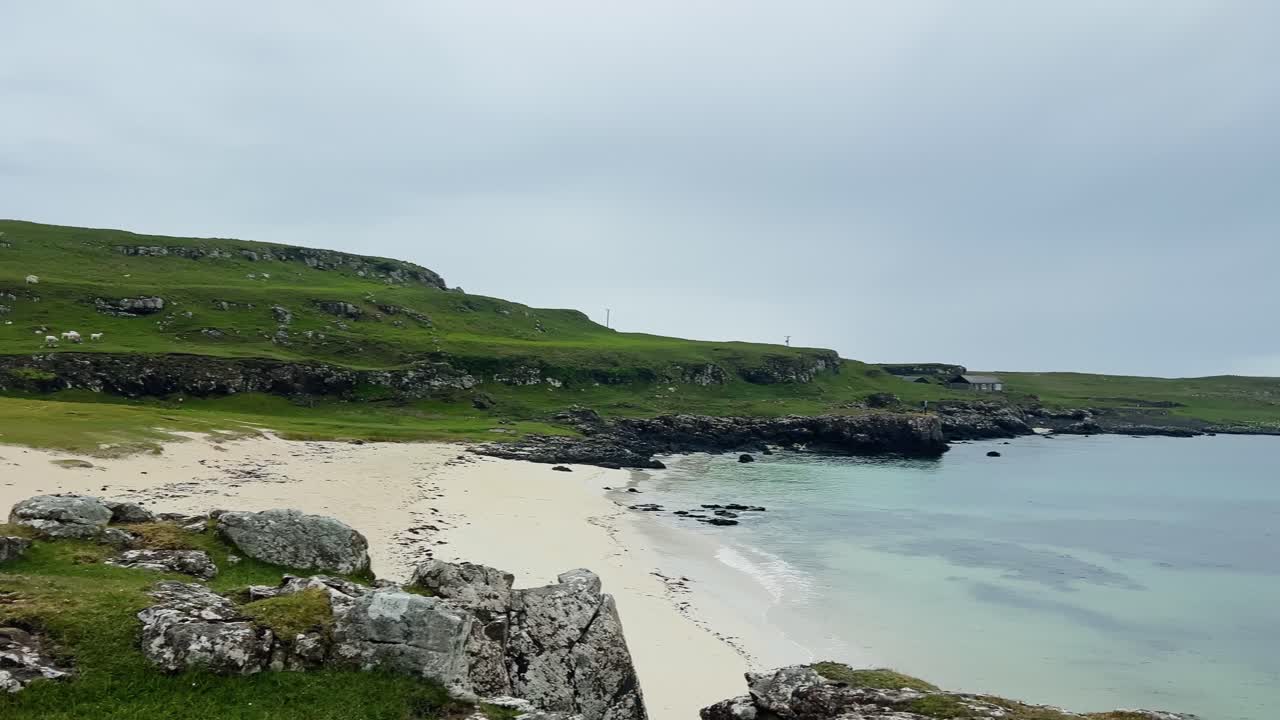 Remote House By The Beach With Rocky Coastline In Port na Ba, Isle Of Mull In Scotland. - wide pan shot