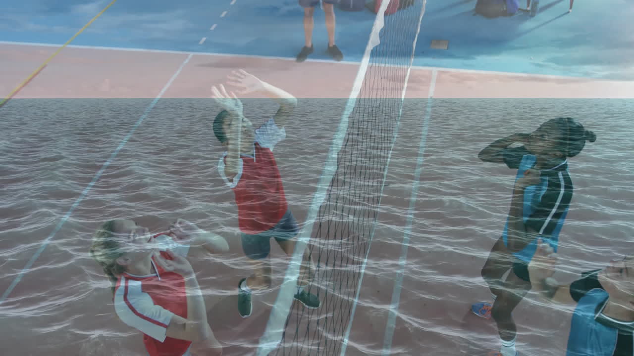 Red team jumping while blue player striking ball under ocean overlay coach observing AR technology