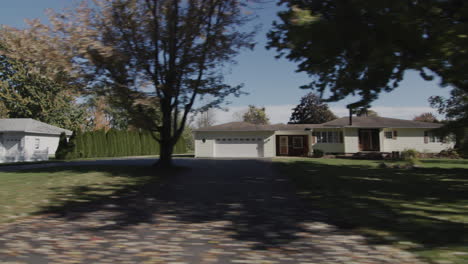 drive along a typical street of an american town on a clear autumn day. side view