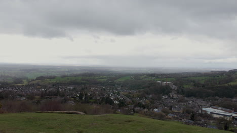 a view of bollington village in the peak district in england from a hilltop
