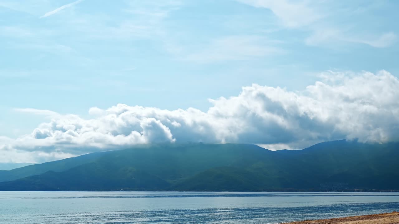 Hyperlapse of the Aegean sea and a mountain visible in the distance, moving clouds in Greece