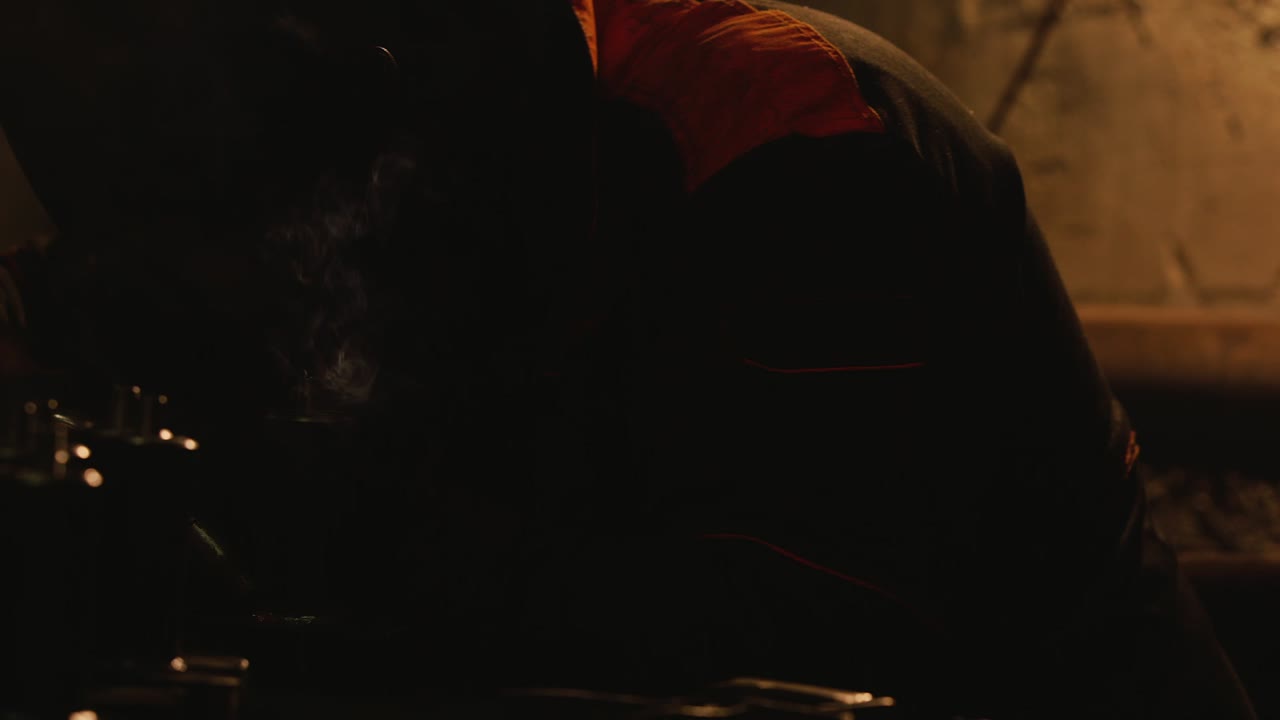 A welder in a protective helmet and clothes welds as sparks fly 10