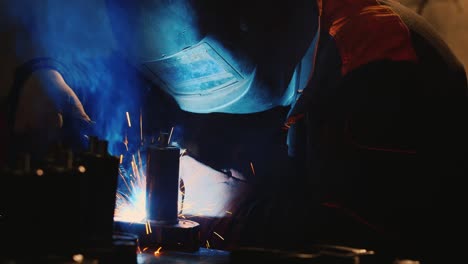 A-welder-in-a-protective-helmet-and-clothes-welds-as-sparks-fly-10