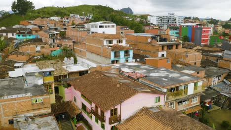 rising aerial shot reveal brick homes in poor city of guatape, colombia