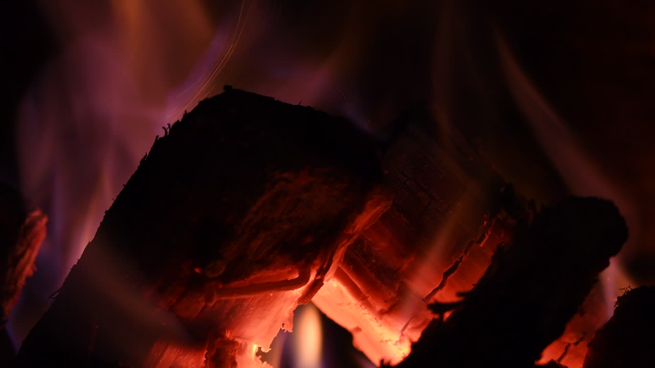 logs burning red hot in a fireplace 8