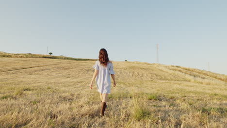 woman walking through a field