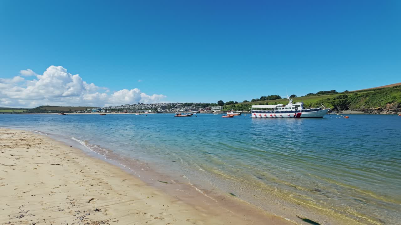 Pan from left to right of view across estuary of Padstow from Daymer Bay, Cornwall, UK